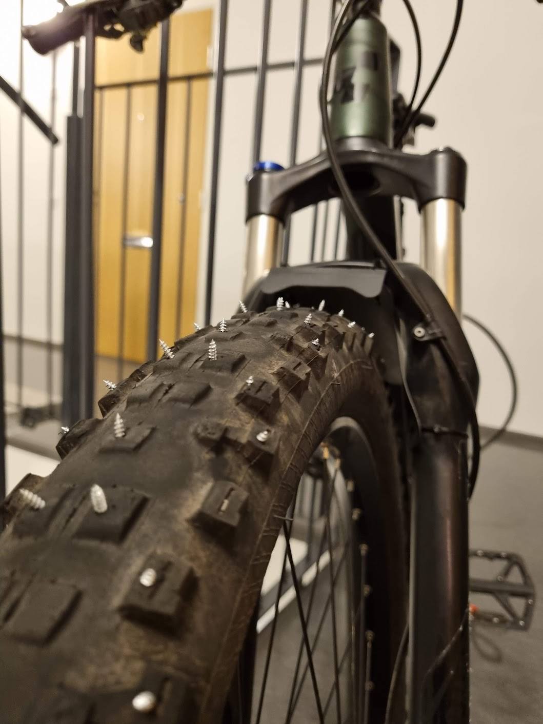 Worn-out MTB tyres turned into DIY studded-tyres with screws
