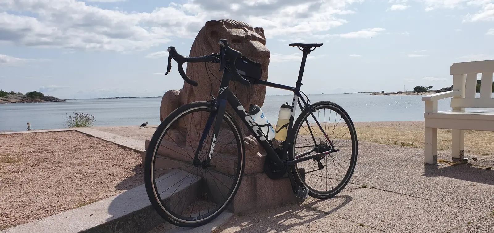 A road bike leaning towards a statue in Hanko, Finland