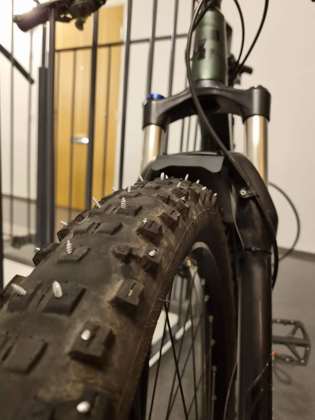 Worn-out MTB tyres turned into DIY studded-tyres with screws