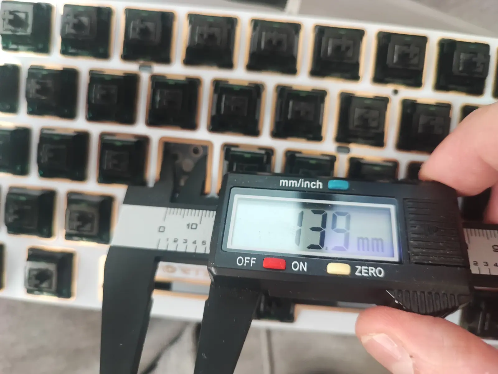 Meassuring the switch hole cutouts with a caliper