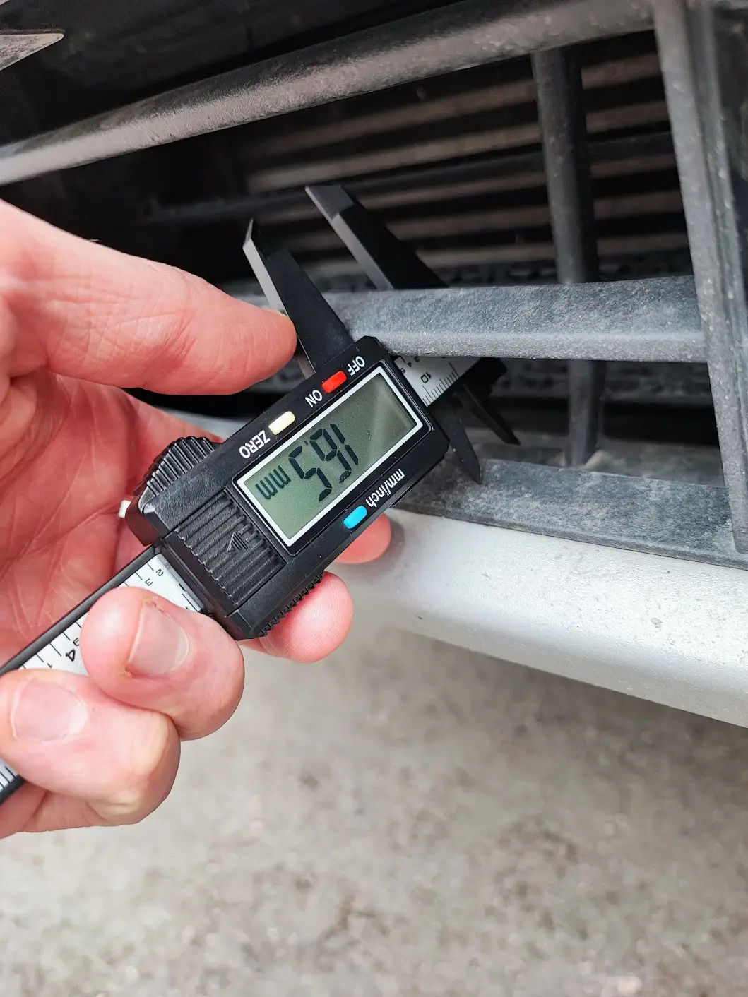 Measuring car front grille with a caliper