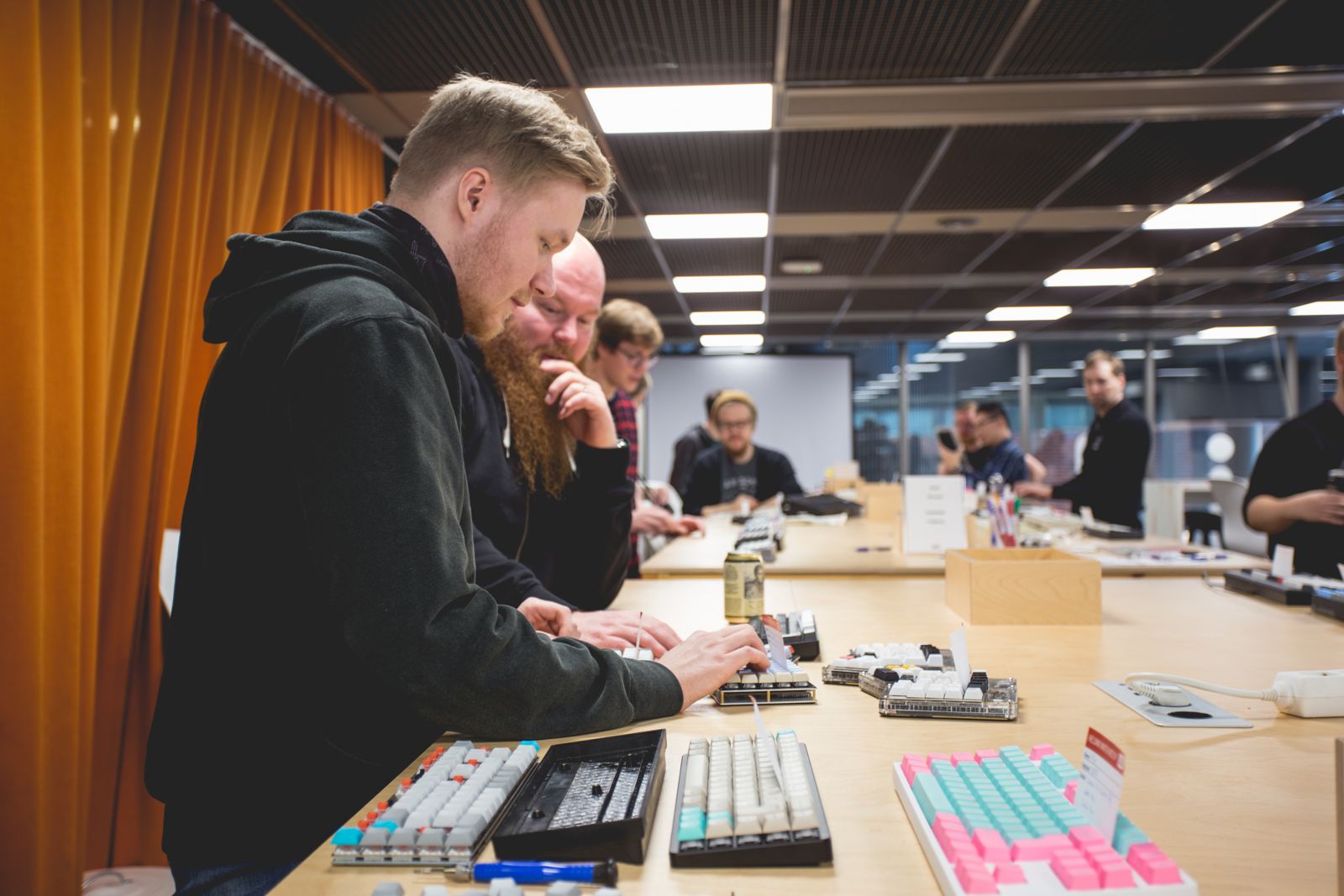 Keyboard enthusiasts testing keyboards at a meetup