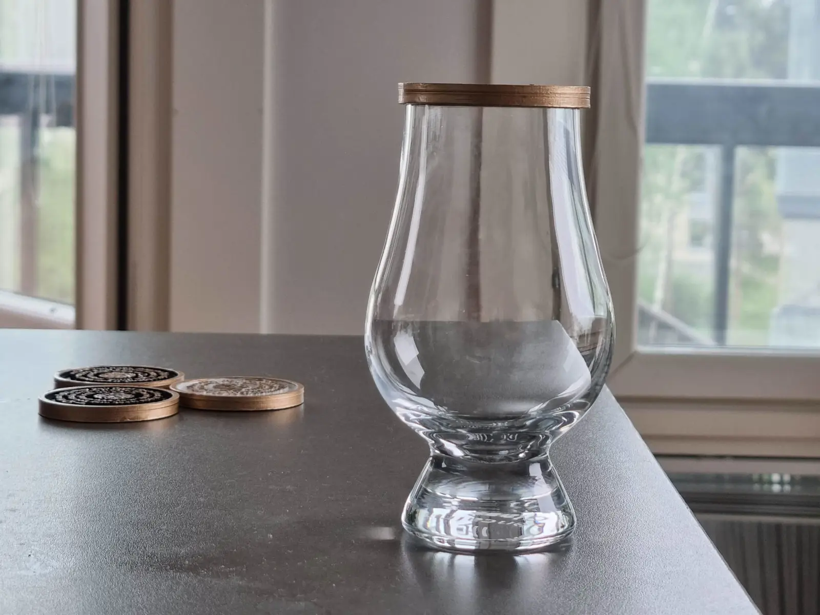 Example of the challenge coin in use as a lid for a GlenCairn glass